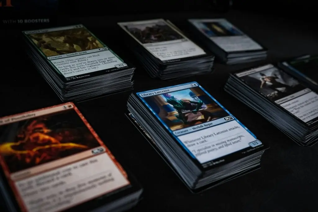 Stacks of Magic: The Gathering cards on a dark table
